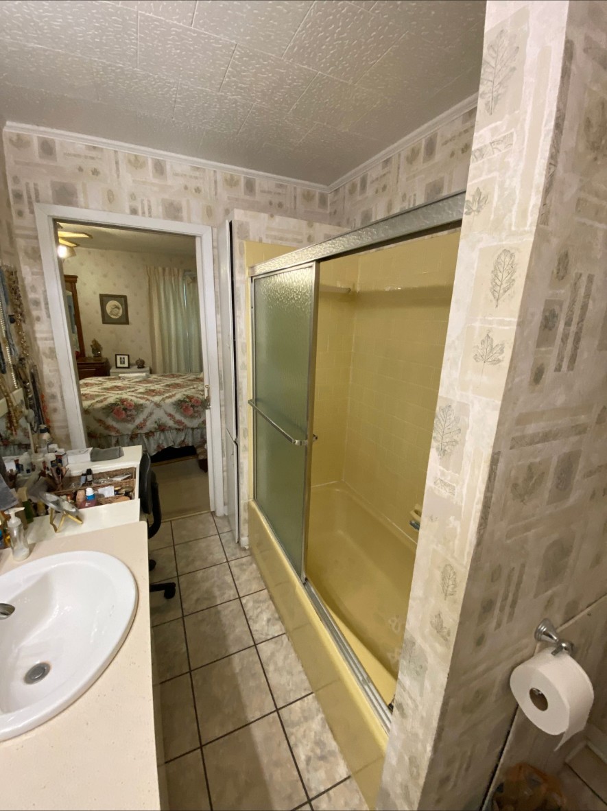 Outdated yellow tub and shower before the remodel